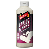 A 500ml bottle of Crucials Mild & Herby Garlic Sauce, with a white cap and black and pink label, filled with their signature garlic sauce.